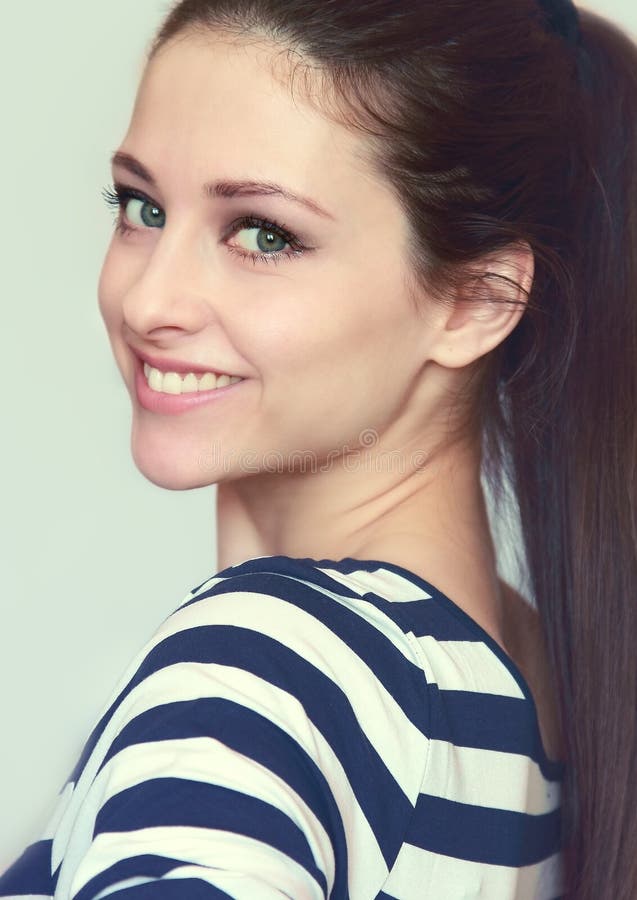 Closeup portrait of smiling teen girl with long hair isolated