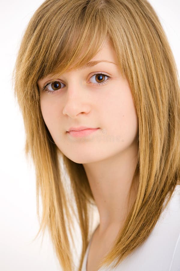 Closeup portrait of pretty teenage girl with long blond hair and big brown eyes, smiling. Isolated on white background. Closeup portrait of pretty teenage girl with long blond hair and big brown eyes, smiling. Isolated on white background.