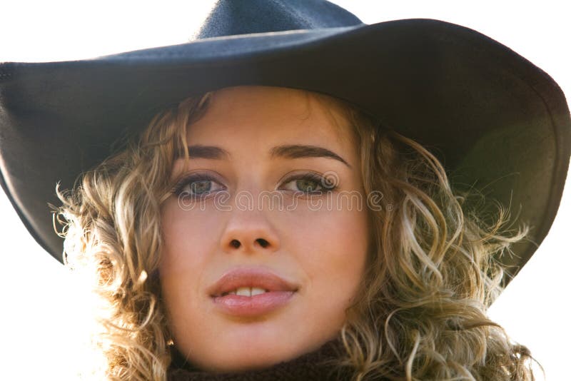 Closeup portrait of young blond woman in a hat