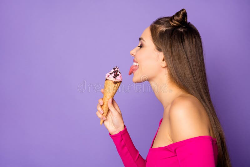 Closeup profile photo of funny lady stick tongue out mouth lick delicious, vanilla ice cream delighted wear pink off-shoulders cropped top isolated pastel purple color background. Closeup profile photo of funny lady stick tongue out mouth lick delicious, vanilla ice cream delighted wear pink off-shoulders cropped top isolated pastel purple color background