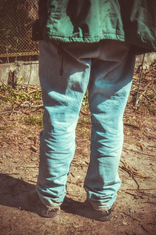 Closeup Rear View of the Legs of a Man in Old Blue Jeans and Old Shoes ...
