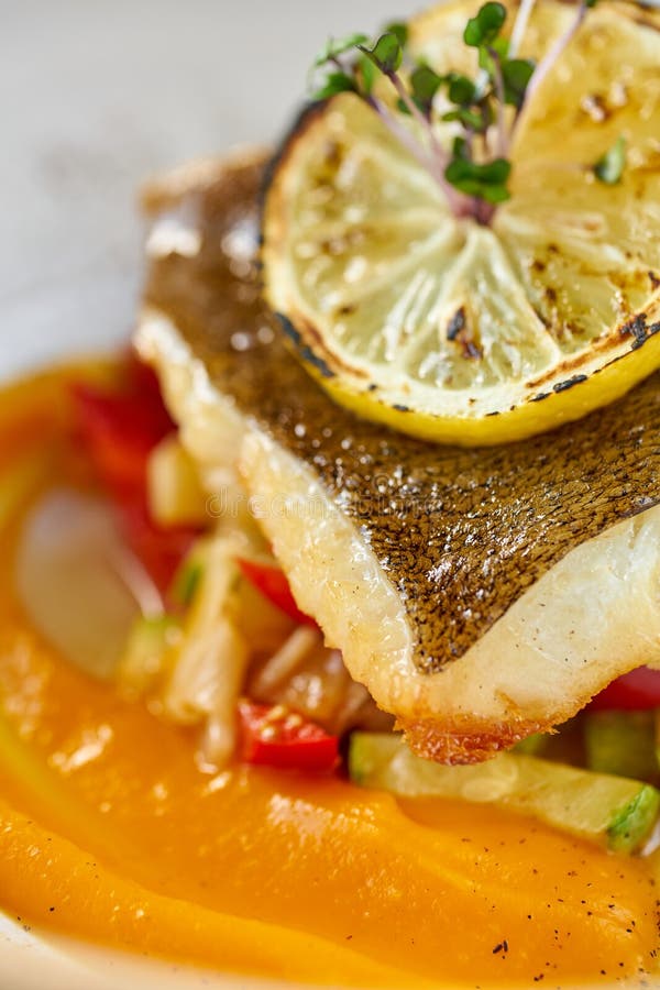 Closeup Roasted Pike Perch or Cod Fish with Baked Vegetables. Dish