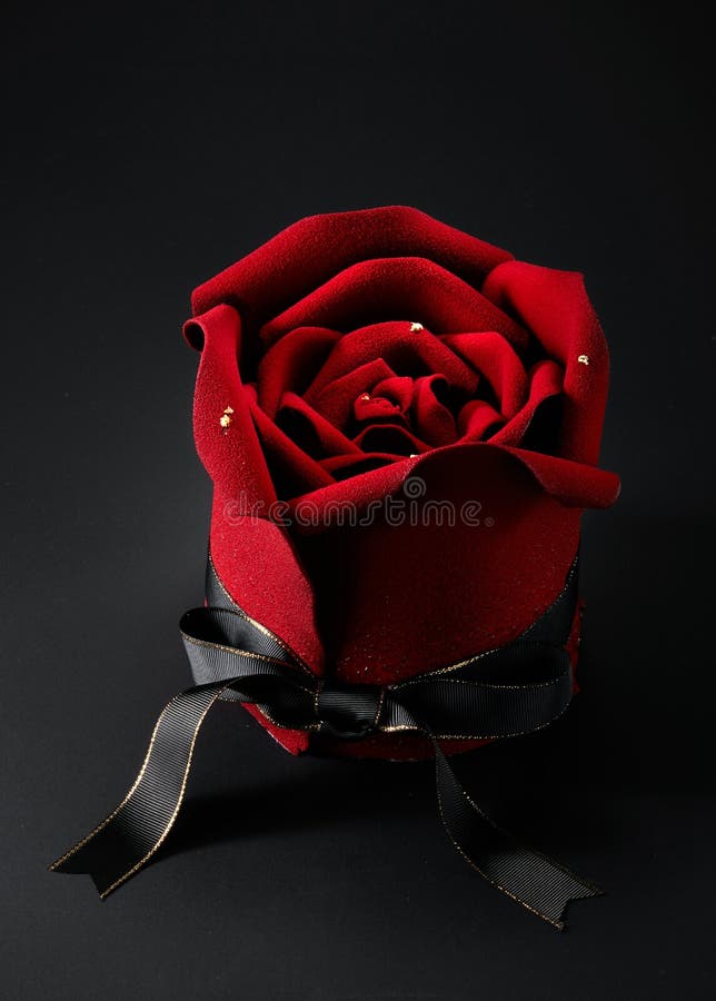 Closeup of rose flower shaped cake over black background