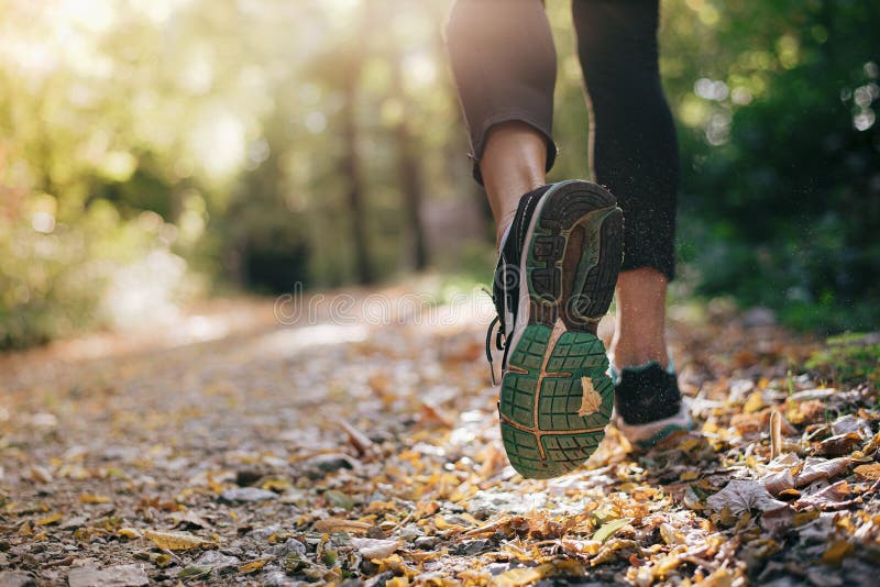 Closeup of running shoe of the person running in the nature