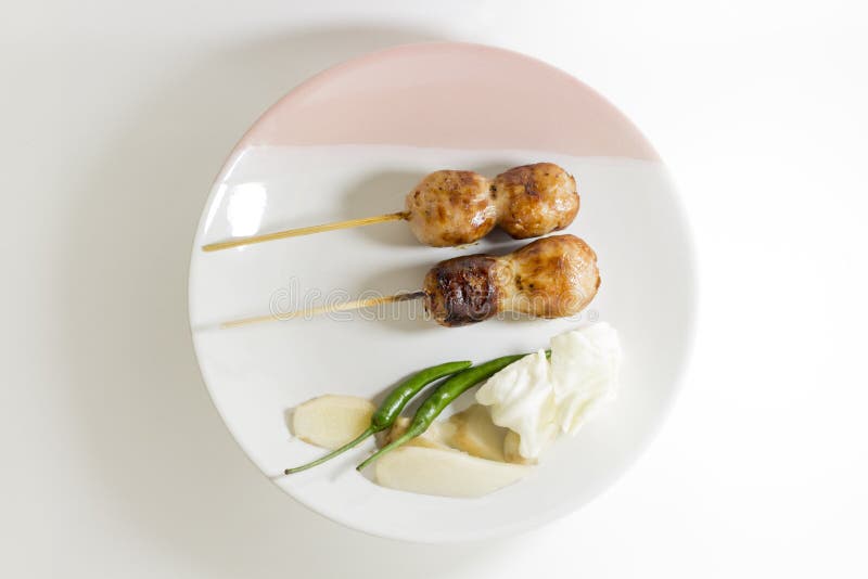 CloseUp, Sausage grill Two wooden With chilli Cabbage and ginger On a white plate stock photo CloseUp, Sausage grill Two wooden With chilli Cabbage and ginger On a white plate stock photo