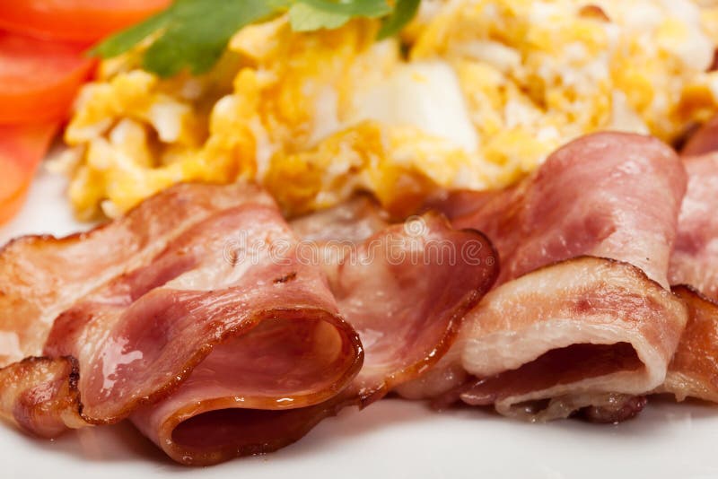 Closeup of scrambled eggs with bacon stock photo