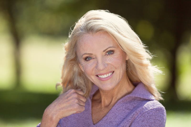 Closeup Of A Senior Woman Smiling At the Camera At The Park