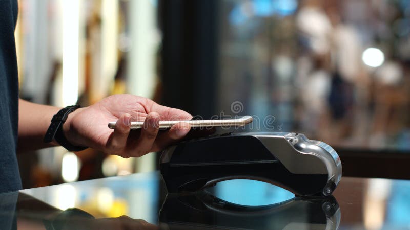 Closeup shoot a young man using his smart phone to paying