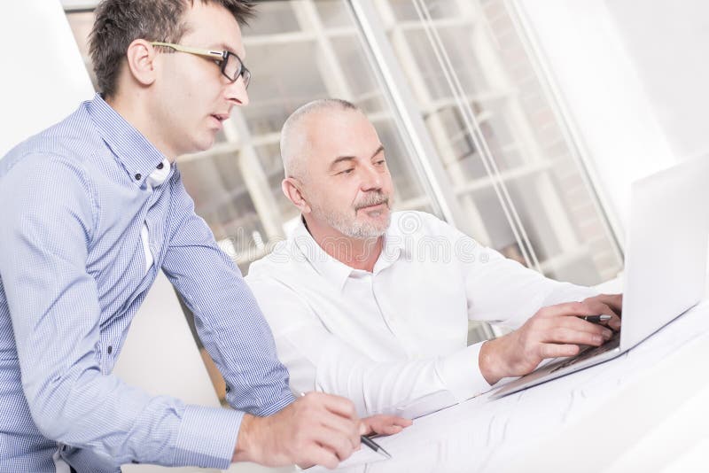 Closeup shot of an architect discussing the project with his male assistant stock images