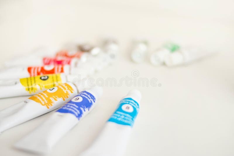 Closeup shot of assorted paint tubes on a white surface royalty free stock photos