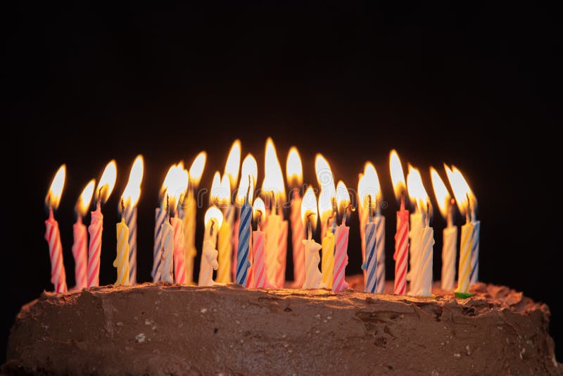 Closeup Shot of a Birthday Cake with Lighted Colourful Candles on a ...