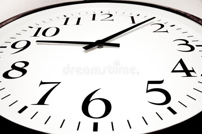 Closeup Shot of the Black Numbers and Hands of a White Clock Stock
