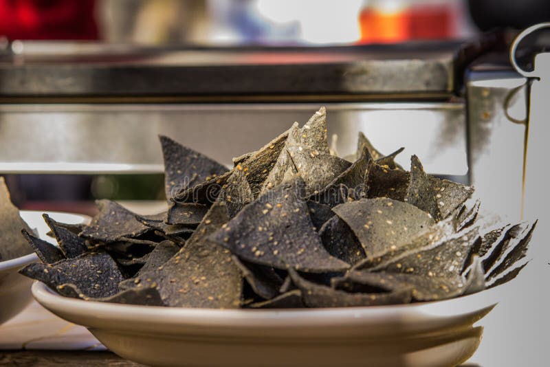 Closeup Shot of Black Tortilla Chips in a Bowl with Blur Background