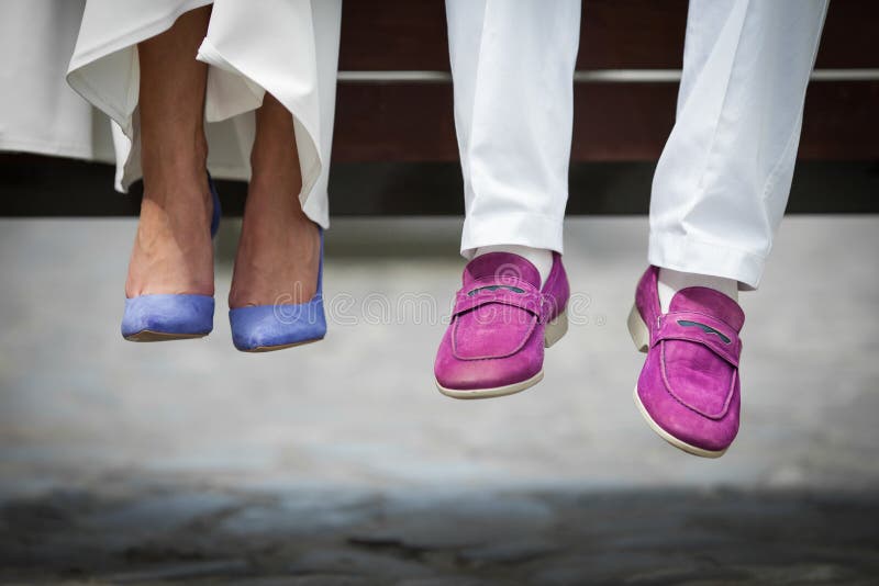 Closeup shot of bride and groom shoes: blue and purle closeup