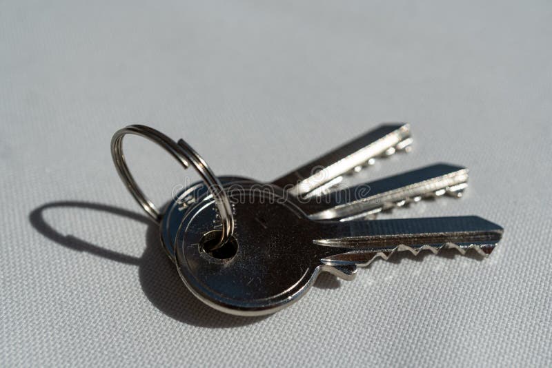 Closeup shot of a bunch of keys on a grey surface royalty free stock image