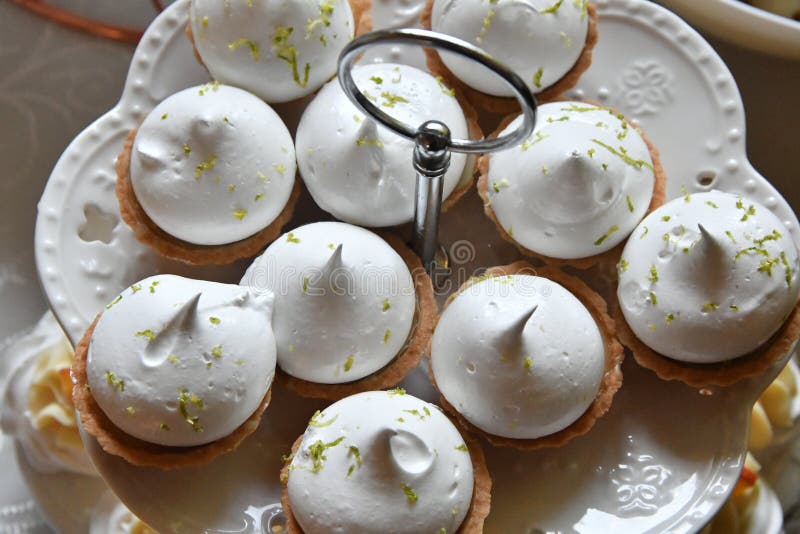 A closeup shot of cupcakes with white cream and lemon peels