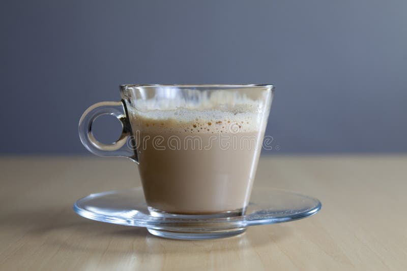 Close-up of espresso coffee in a single shot glass cup with saucer