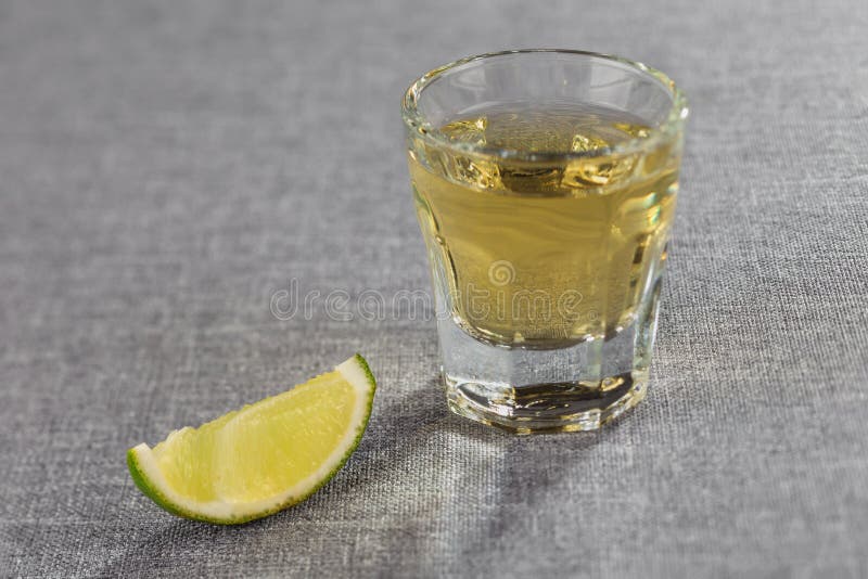 Closeup Shot of Gold Tequila with Lime Slice. Diagonal Sharpness. Stock