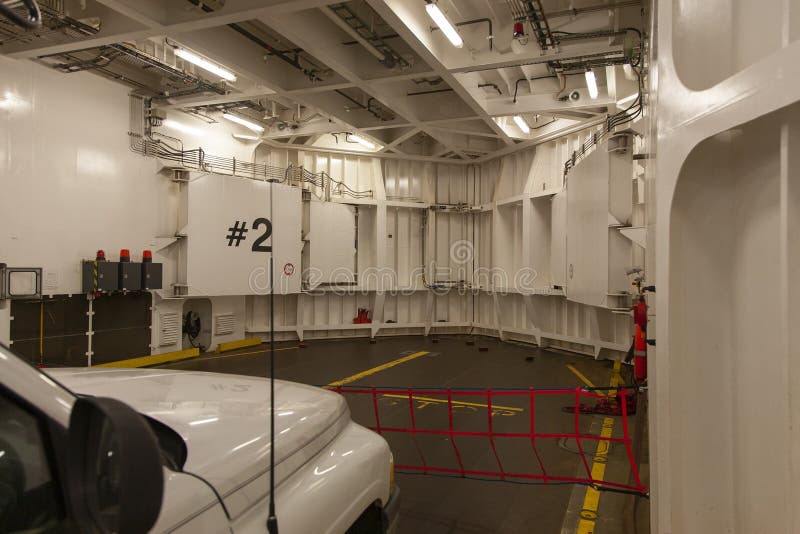 Closeup Shot of an Inside of a Ferry on the Car Deck with a White Car