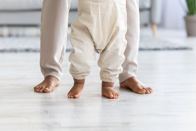 Closeup Shot Of Little Baby& x27;s And Mother& x27;s Legs, Child Making Fist Steps