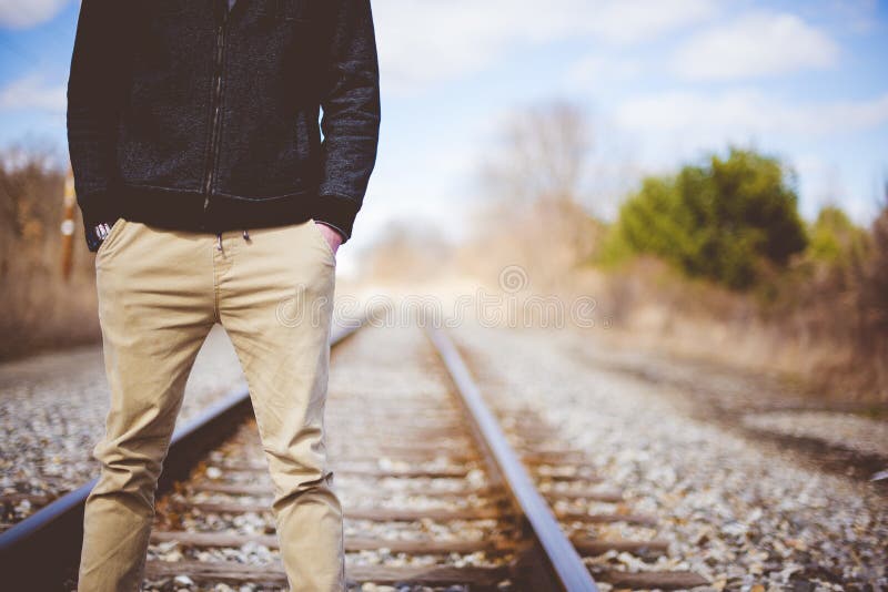 Closeup Of Man Standing On Train Tracks Stock Photo - Image of traveler ...