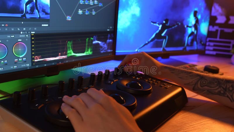 Video and photo editing advertisement concept. Freelancer working from home. Closeup shot of man hands at the desk working using mixer and editing video, changing settings and colors. Editing project stock images, royalty-free photos and pictures