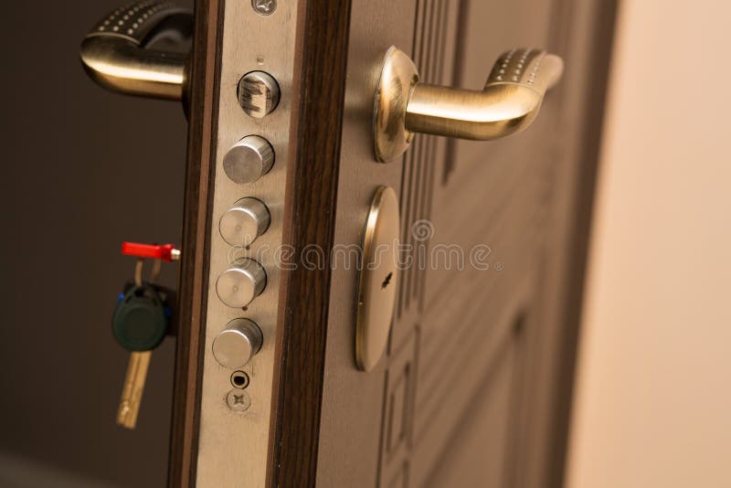 Closeup shot of modern door lock with a key. Empty space stock photo