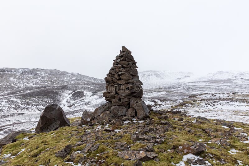 Closeup shot of an old stone cairn in winter landscape in Iceland