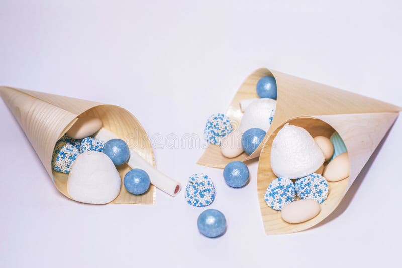 Closeup shot of paper cons filled with decorative shells and candy for a wedding table stock image
