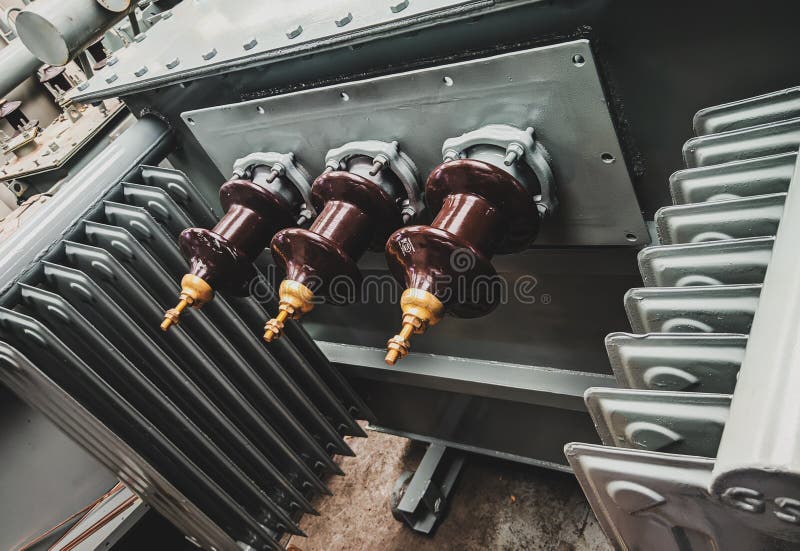 Closeup shot of 3-phase distribution transformer Bushings with porcelain insulator.