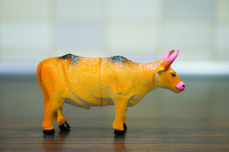 Closeup Shot of a Plastic Toy Bull on a Wooden Surface Stock Photo Image of enchanted, fairy