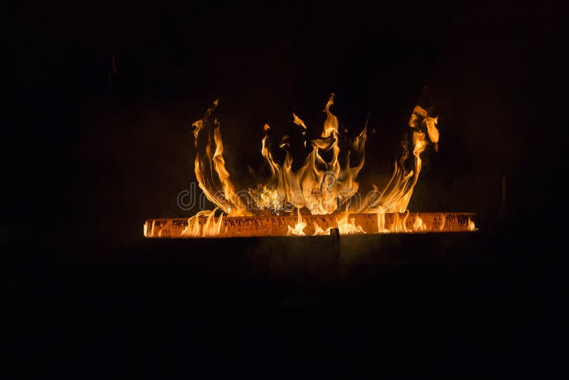 Closeup Shot of a Red Hot Iron with Flames with a Black Background