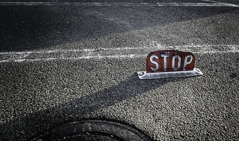 Closeup Shot of a Red Stop Sign in the Middle of the Road during