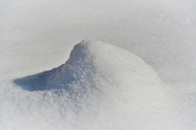 Closeup shot of a small snow dune during daytime in winter stock photography