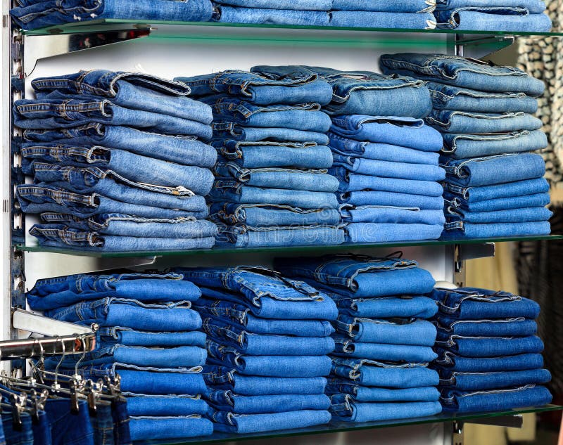 Closeup shot of stack of folded jeans stock images