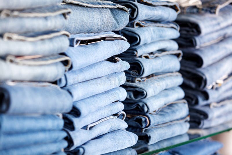 Closeup shot of stack of folded jeans stock photography