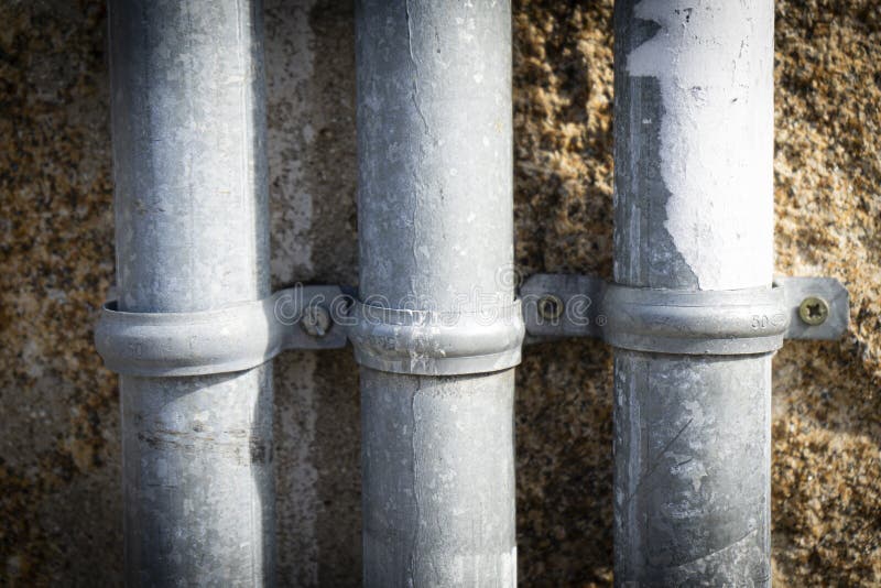Closeup Shot of Three White Water Tubes on the Wall Stock Photo Image