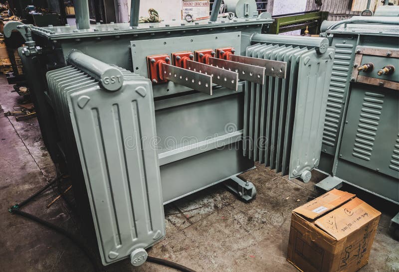 Closeup shot of transformer tank with LV bushings and radiators.