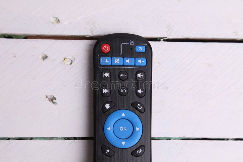 Closeup shot of TV remote control on wooden background royalty free stock photography