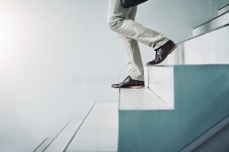 Every step will bring you closer to great success. Closeup shot of an unrecognizable businessman walking down a stock images