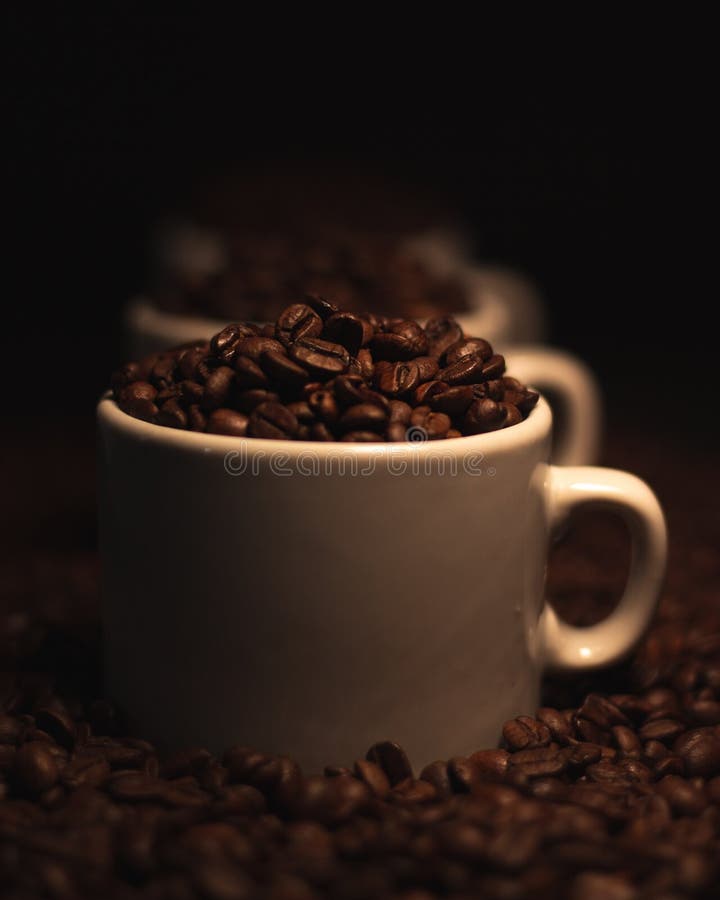 Closeup Shot Of White Coffee Mugs Filled With Roasted Coffee Beans