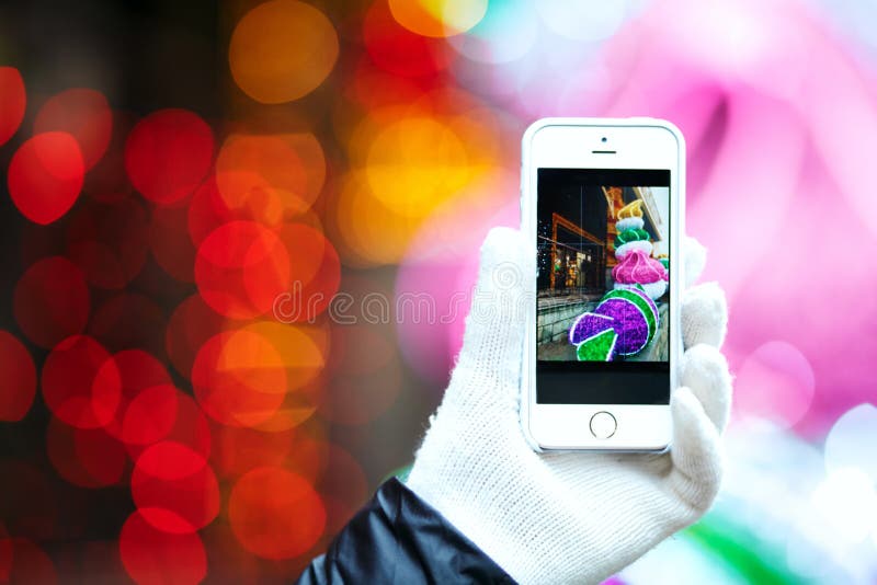 Closeup shot of woman`s hand holding smart phone over a cityscap royalty free stock photo