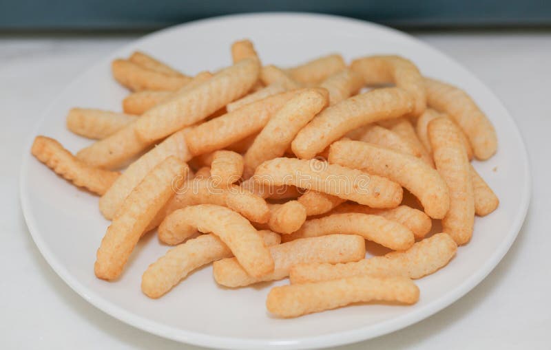 Closeup Shrimp Cracker Chips on a White Paper Plate. Stock Photo