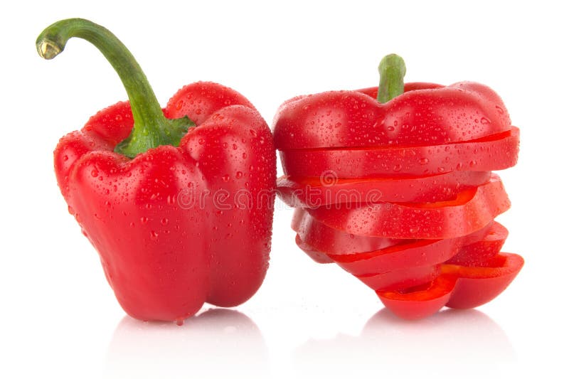 Closeup slices of red bell peppers on white with drops of water