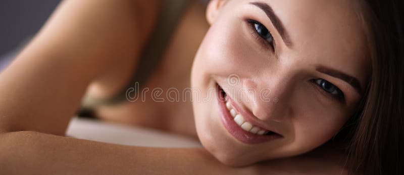 Closeup of a smiling young woman lying on couch stock images Closeup of a smiling young woman lying on couch stock images