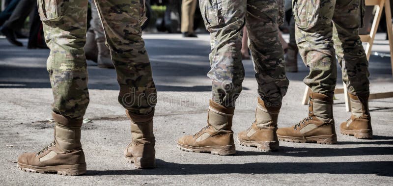 Closeup of Soldiers in a row. Detail of Military boots and camouflage uniforms stock images