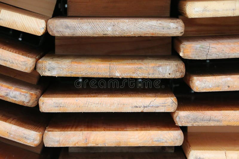 Closeup of a stack of folded wood party tables and benches stock photo