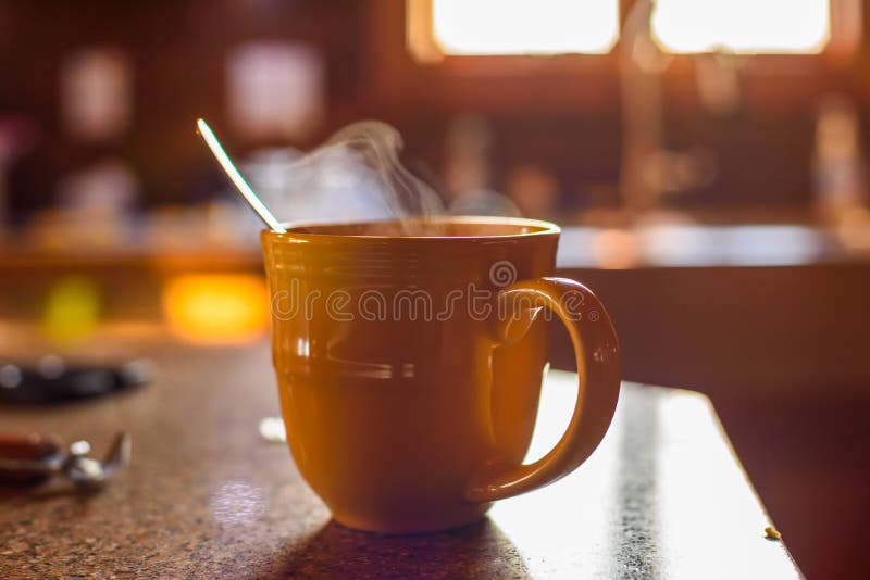 Steaming hot beverage on the countertop in early morning light stock images Steaming hot beverage on the countertop in early morning light stock images