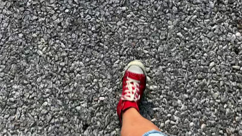 Closeup steps on the road in red shoes