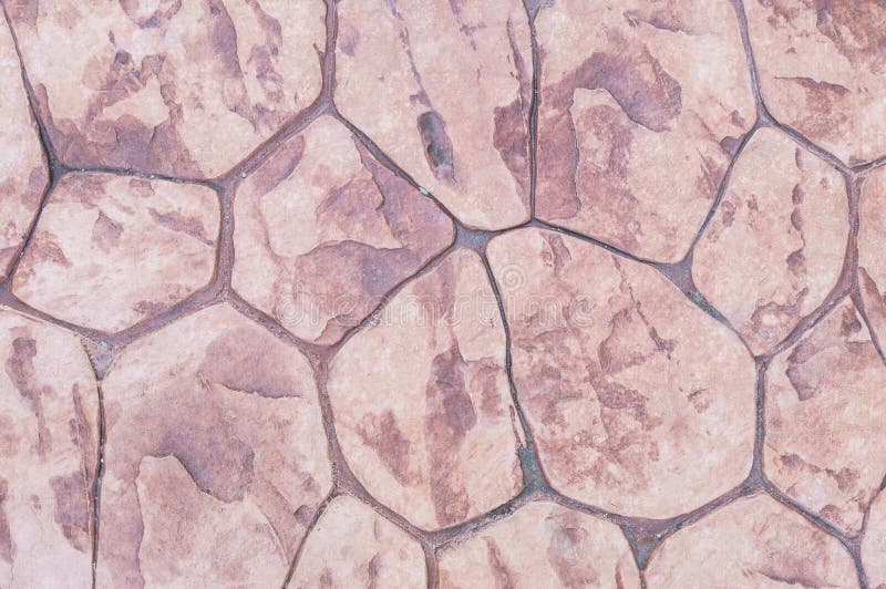 Closeup surface brick pattern at old red stone brick floor at pathway texture background